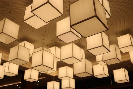 Illuminated geometric ceiling lamps create a modern interior ambiance.